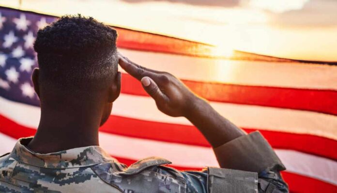A,Soldier,In,Uniform,Salutes,The,American,Flag,During,A