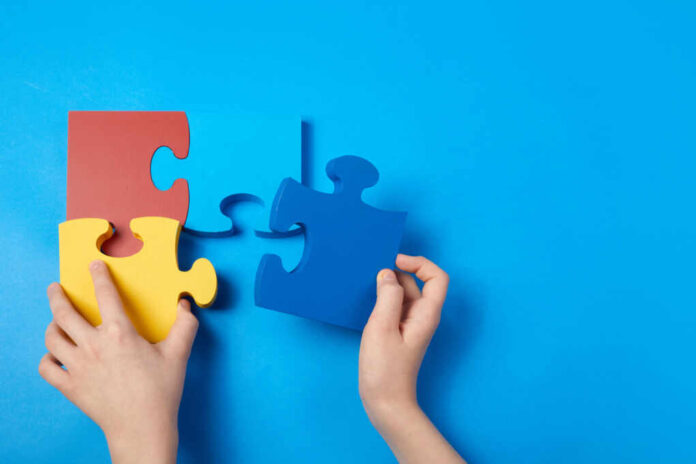 Top,View,Hands,Of,A,Autistic,Child,Arranging,Color,Puzzle