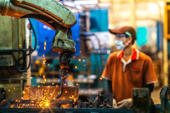 Asian,Worker,Working,In,Old,Chinese,Factory,In,Robot,Auto