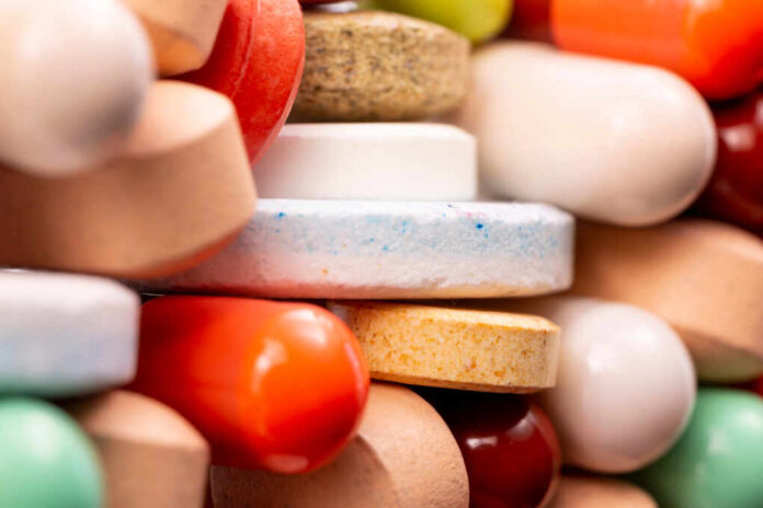 Different,Colorful,Pills,And,Capsules,Stacked.,Global,Pharmaceutical,Industry,For