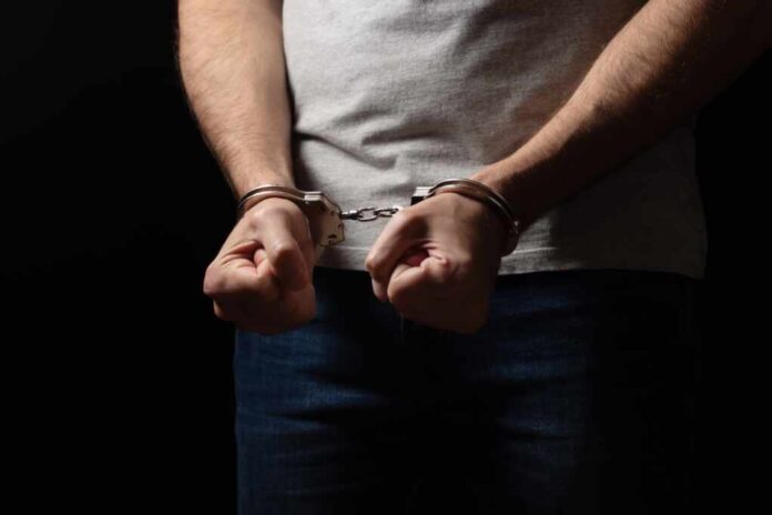 A,Criminal,In,Handcuffs,In,Front.,Arrest,For,Murder.
