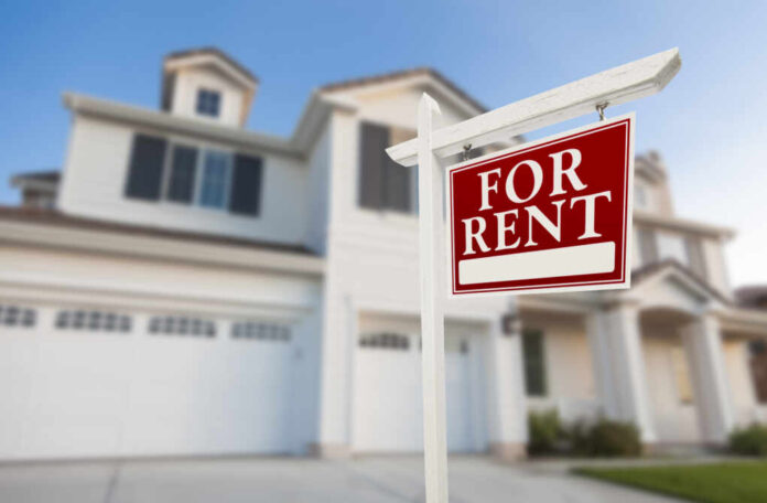 Red,For,Rent,Real,Estate,Sign,In,Front,Of,Beautiful