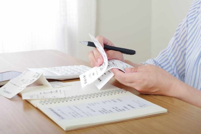 A,Woman,Who,Keeps,A,Household,Account,Book,And,Manages