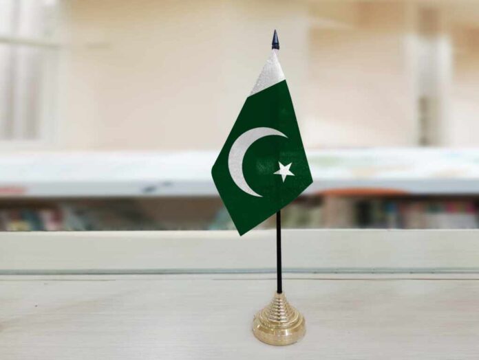 Pakistani,Flag,Flying,On,Table,In,Conference,Room,Background.,News