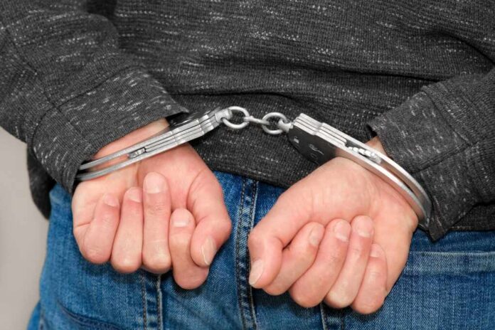 Man,On,The,Chair,In,Handcuffs.,Rear,View,And,Closeup