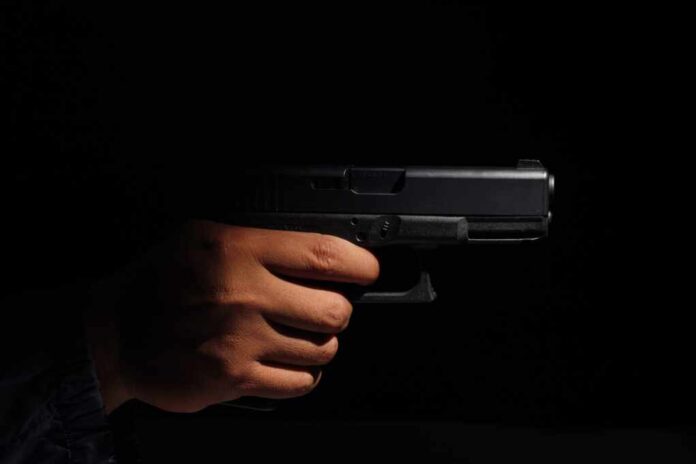 Close-up,Of,A,Man's,Hand,Holding,A,Small,Pistol,Ready