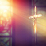 A crucifix illuminated by soft light in a church setting