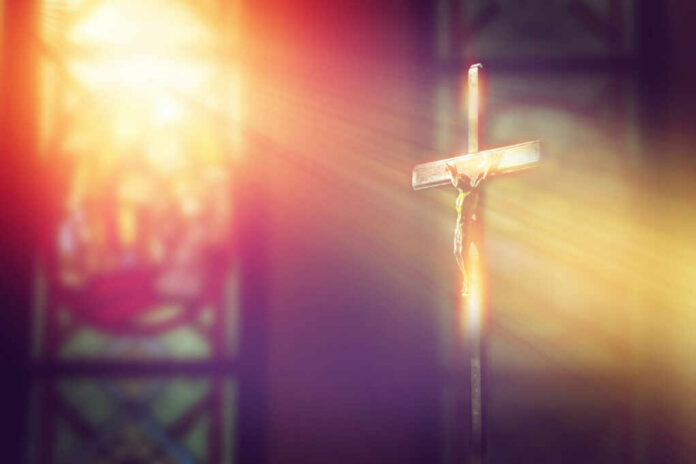 shutterstock1034080006jpg A crucifix illuminated by soft light in a church setting