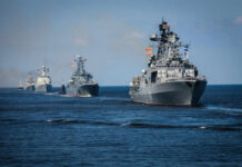 A fleet of military ships sailing in the ocean