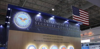 Display booth for the U.S. Department of Defense featuring security cooperation information
