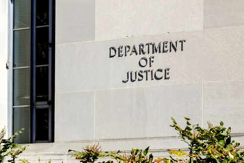 Sign on the exterior wall of the Department of Justice building