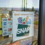 Sign indicating SNAP benefits are accepted at the grocery store