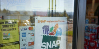 Sign indicating SNAP benefits are accepted at the grocery store