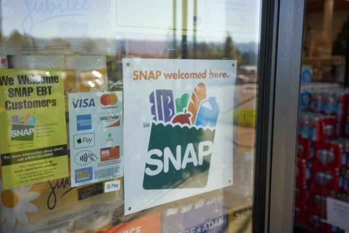 Sign indicating SNAP benefits are accepted at the grocery store