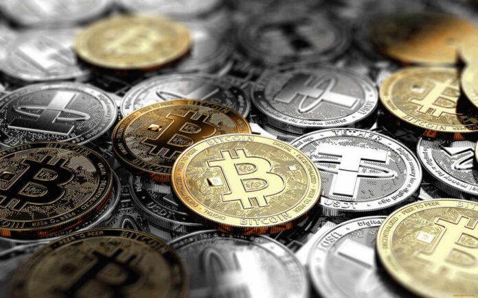 shutterstock_1939111636.jpg A collection of various cryptocurrency coins including Bitcoin and Tether