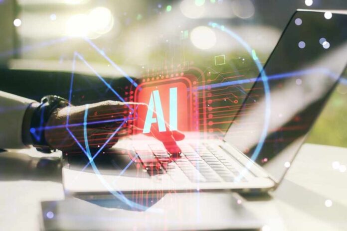 shutterstock_2096306188.jpg A hand interacting with a laptop displaying an AI symbol