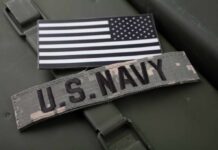 U.S. Navy patch and American flag on a green military surface