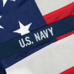 Close-up of the U.S. Navy insignia on an American flag