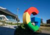 Huge Fines Rock Meta Google Empires Colorful Google logo sculpture in front of a modern building