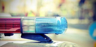 Close-up of a police cars light bar with blue and red lights