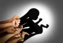 Planned Parenthood Invades Concerts: Fans Surprised A collection of hands creating a shadow silhouette of a fetus