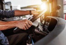 Fuel Price Fury: Mass Protests GRIP Ireland Close-up of a truck driver's hands on the steering wheel inside a vehicle