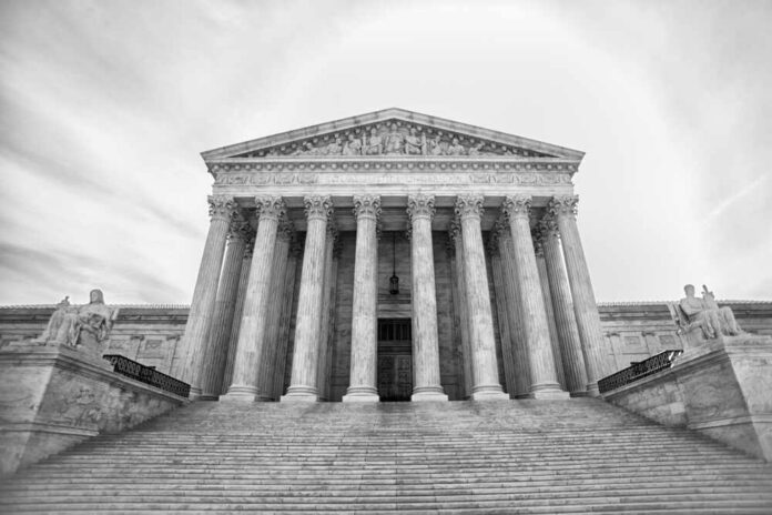 shutterstock_1077112199.jpg Front view of the Supreme Court building with columns and statues