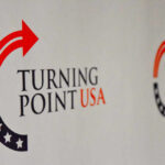 Logo of Turning Point USA displayed on a backdrop