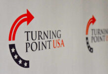 Logo of Turning Point USA displayed on a backdrop