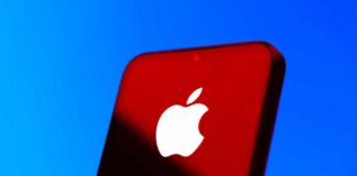 Close-up of a smartphone with the Apple logo against a red and blue background