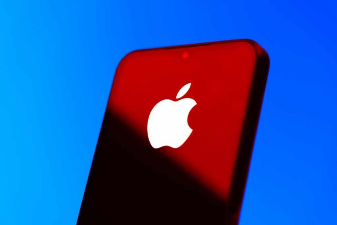 Close-up of a smartphone with the Apple logo against a red and blue background