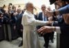 Pope interacting with a crowd of people taking photos