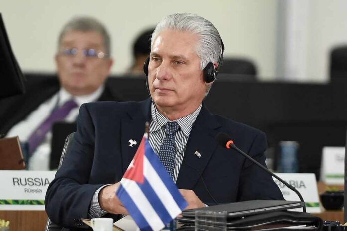 Cuban leader at a political meeting wearing headphones