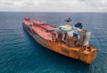 Trump Moves: Massive Oil Reserve Release Announced Aerial view of a large, rusty oil tanker in the ocean