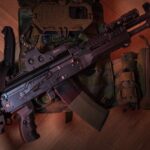 A tactical firearm placed on a military vest with accessories