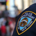 Close-up of a New York City police badge on a uniform