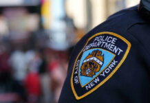 Close-up of a New York City police badge on a uniform