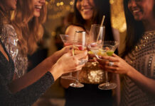 Group of friends toasting with cocktails at a party