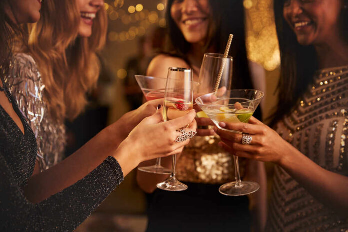 Group of friends toasting with cocktails at a party