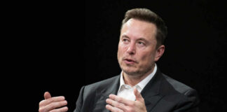 A business leader speaking during an interview, using hand gestures for emphasis