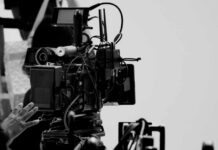 ‘America First’ Show EXPLOSION: Distrust in Legacy Media Close-up of a film camera with various cables and equipment in a studio setting