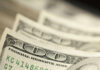 Close-up of several one hundred dollar bills stacked together