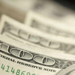 GOP Threatens Defunding Over Speech Cancellation Close-up of several one hundred dollar bills stacked together