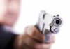 Close-up of a handgun pointed towards the viewer