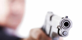 Close-up of a handgun pointed towards the viewer