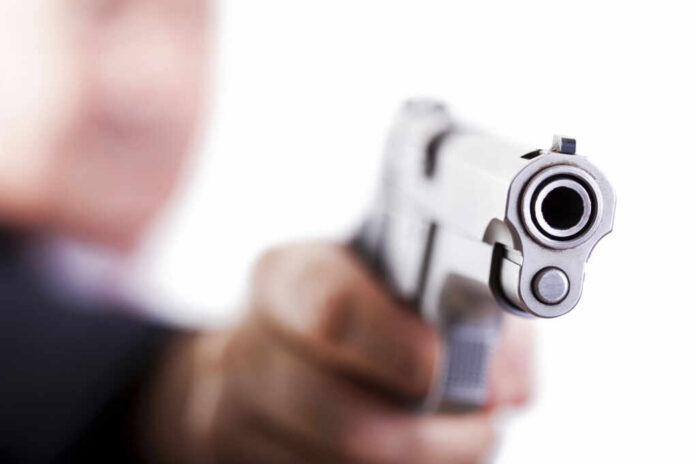 Close-up of a handgun pointed towards the viewer