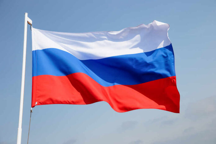 Russia,Flag,Is,Waving,In,Front,Of,Blue,Sky. Russian flag waving against a clear blue sky