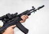 Hamas Atrocities Unveiled: Disturbing New Evidence Person holding an AK-47 rifle with a scope