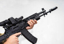 Hamas Atrocities Unveiled: Disturbing New Evidence Person holding an AK-47 rifle with a scope