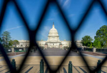 View of the U.S. Capitol building through a security fence